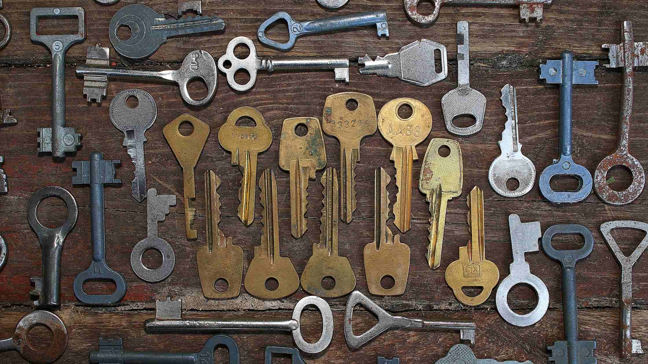 API security concept; keys of varying shapes and sizes on a wooden board