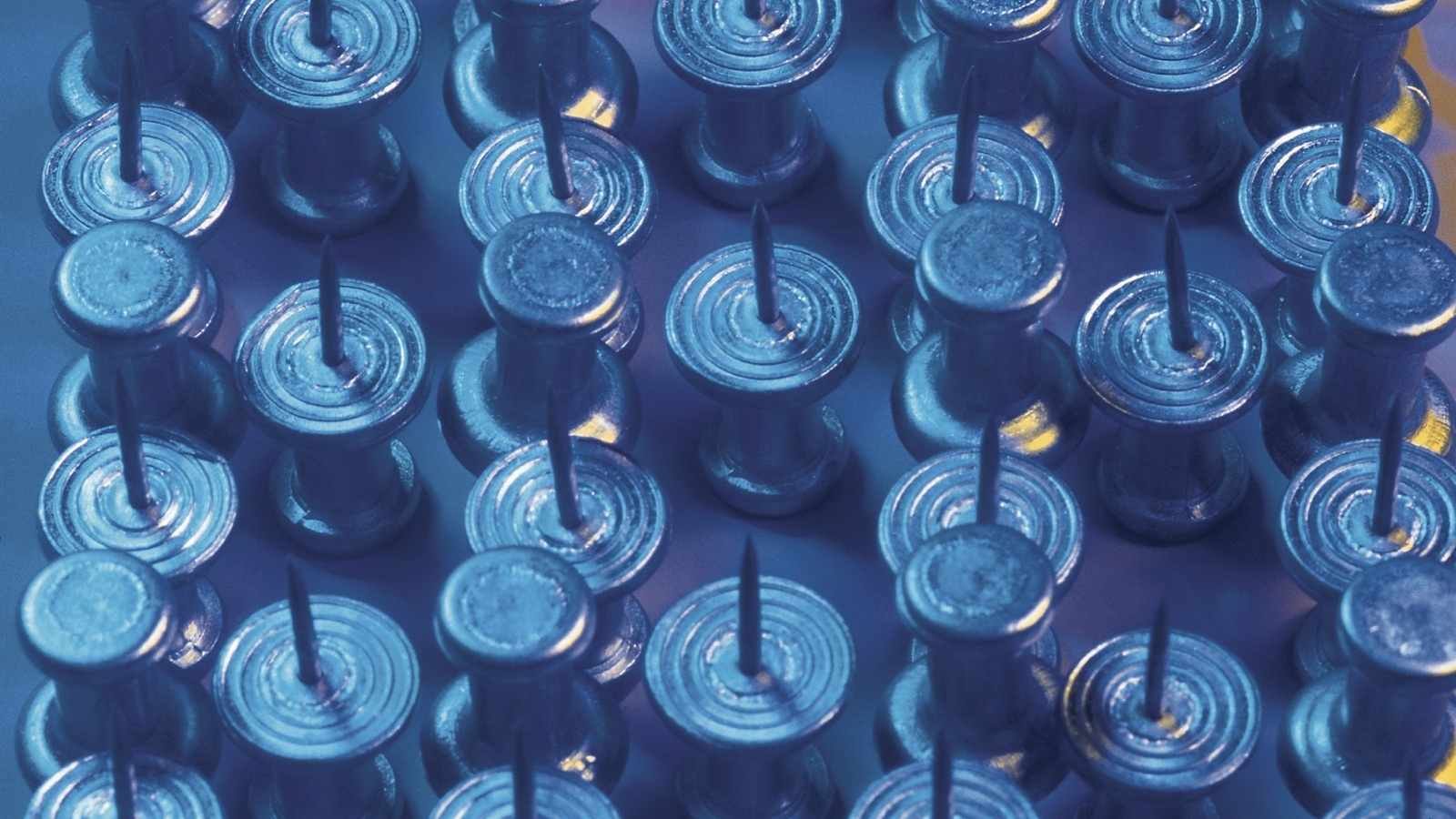 Close up of push pins with blue filter