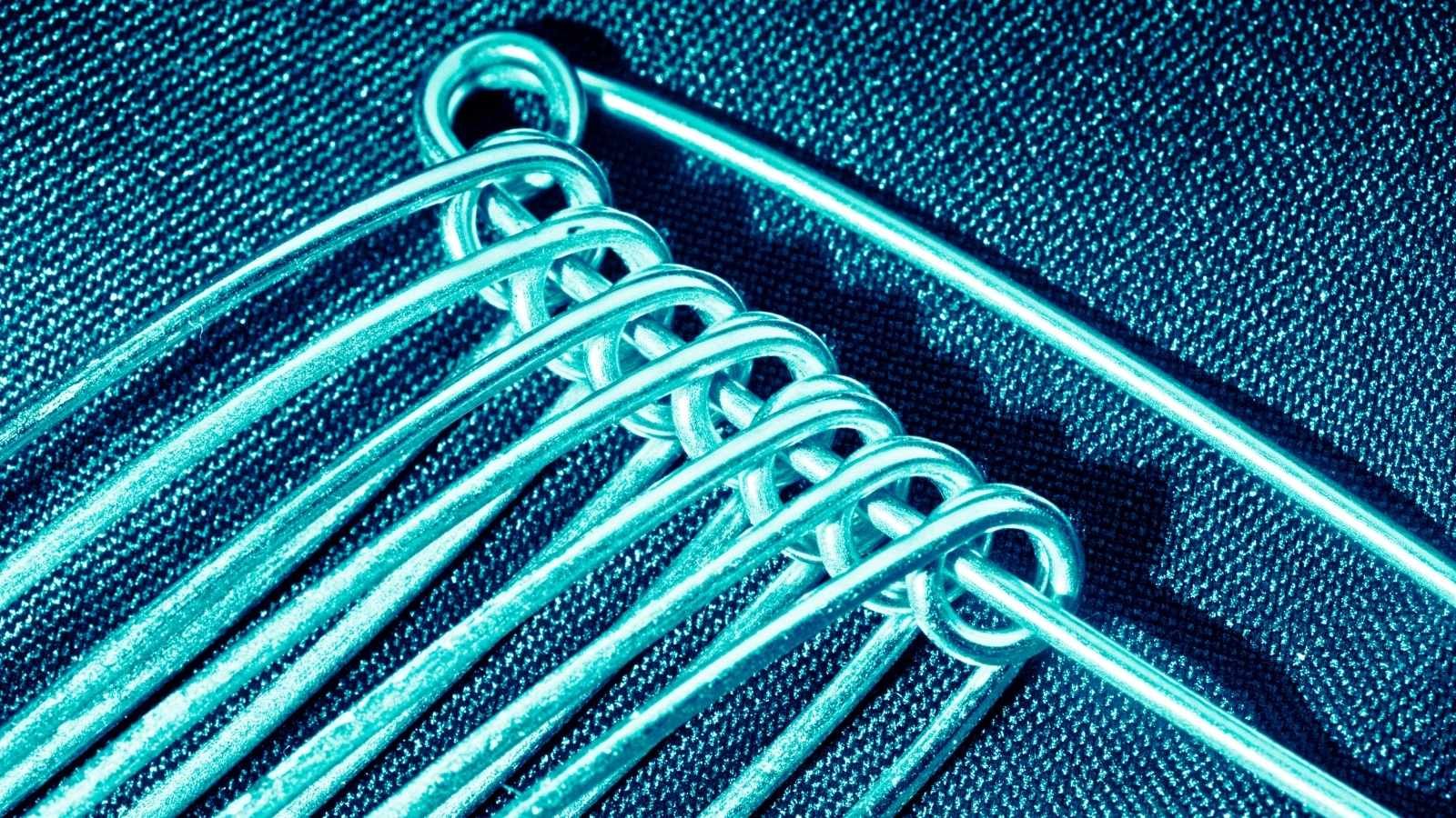 Close up of safety pins with blue filter