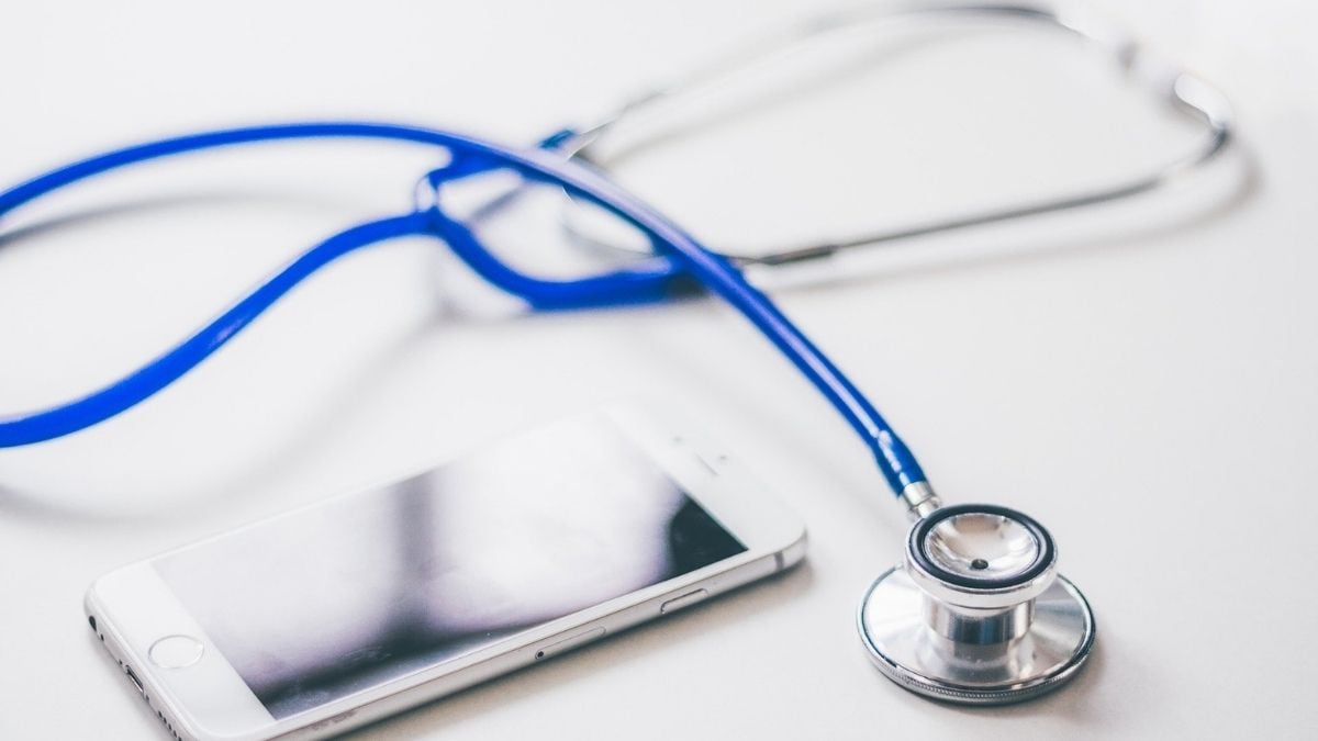 mHealth concept; stethoscope and mobile phone on a white background