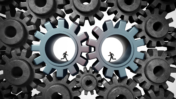 Industry partnership concept_ people running inside cog wheels working as a team-1-1 Industry partnership concept_ people running inside cog wheels working as a team-1-1