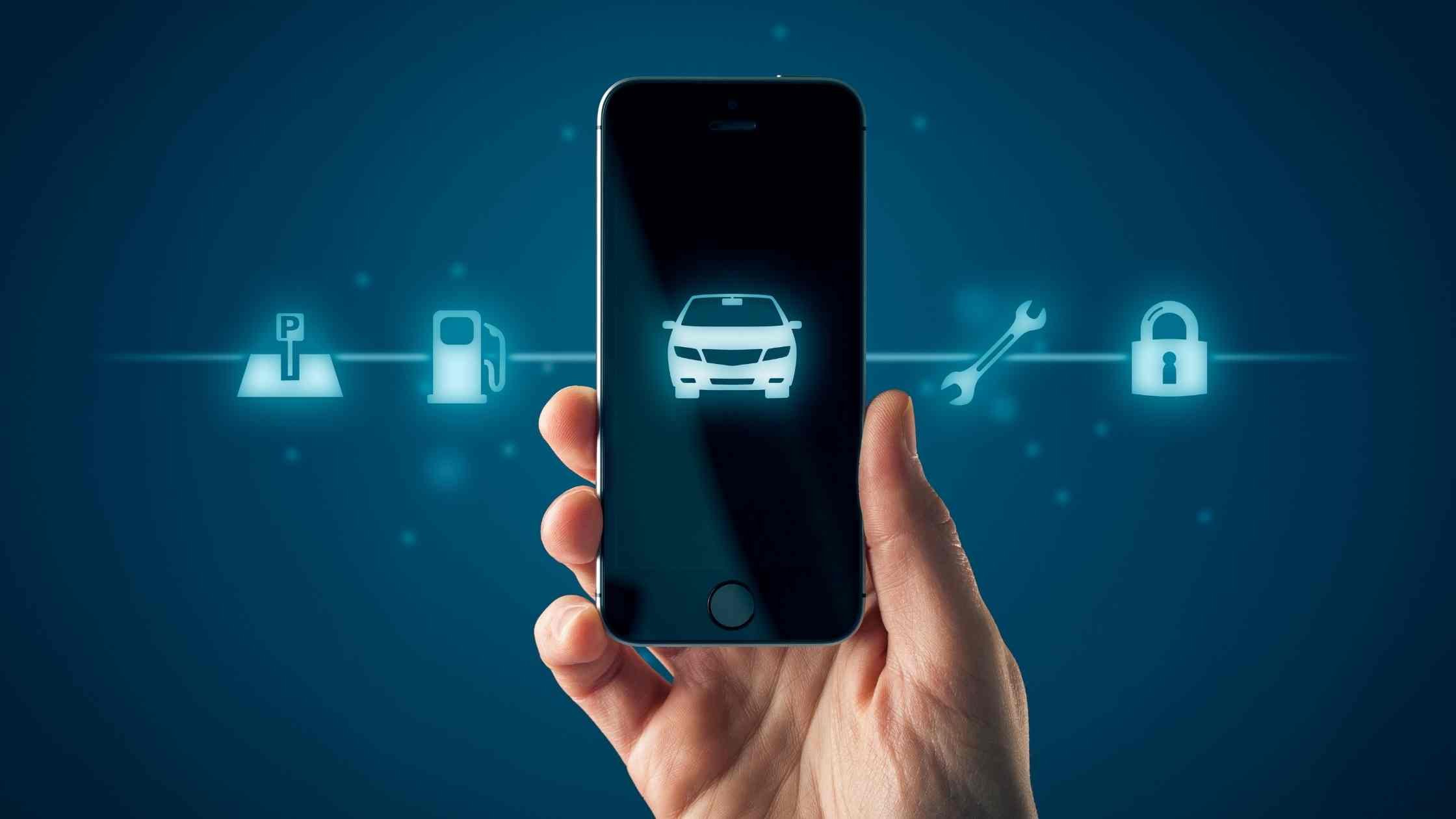 Intelligent car, smart phone app concept; hand holding mobile phone