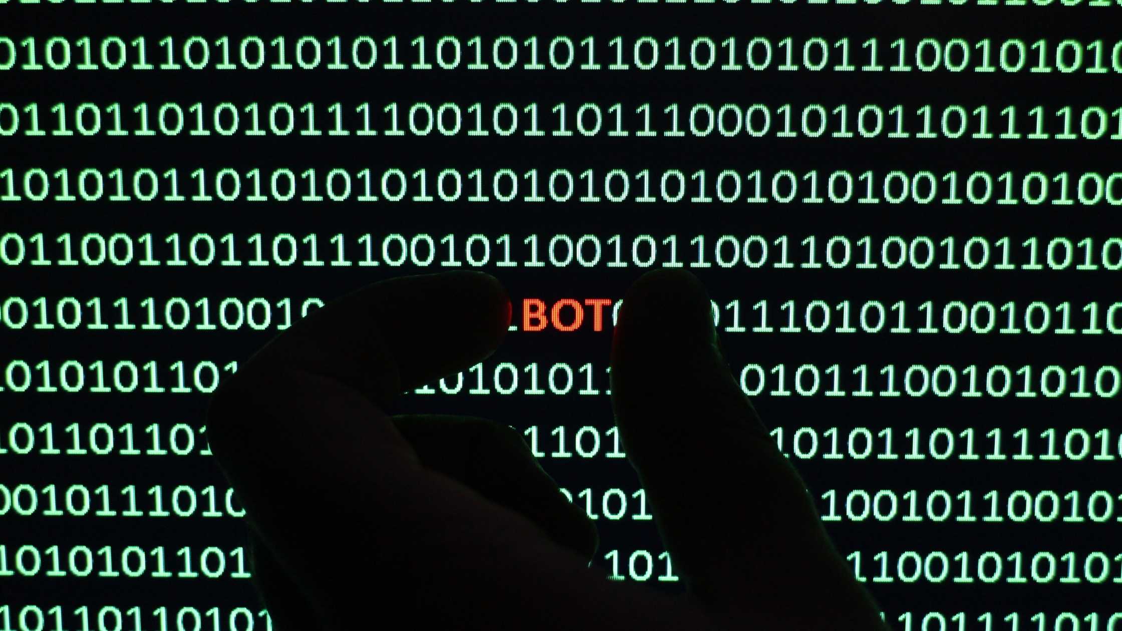 Binary numbers; hand holding the text BOT