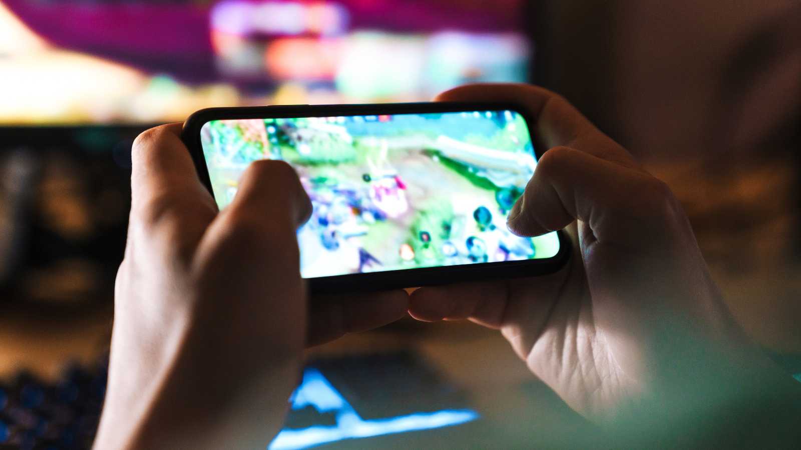Close up of gamer playing on a smartphone