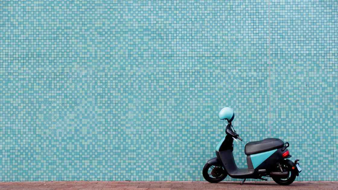 Moped against blue mosaic tiled wall-1