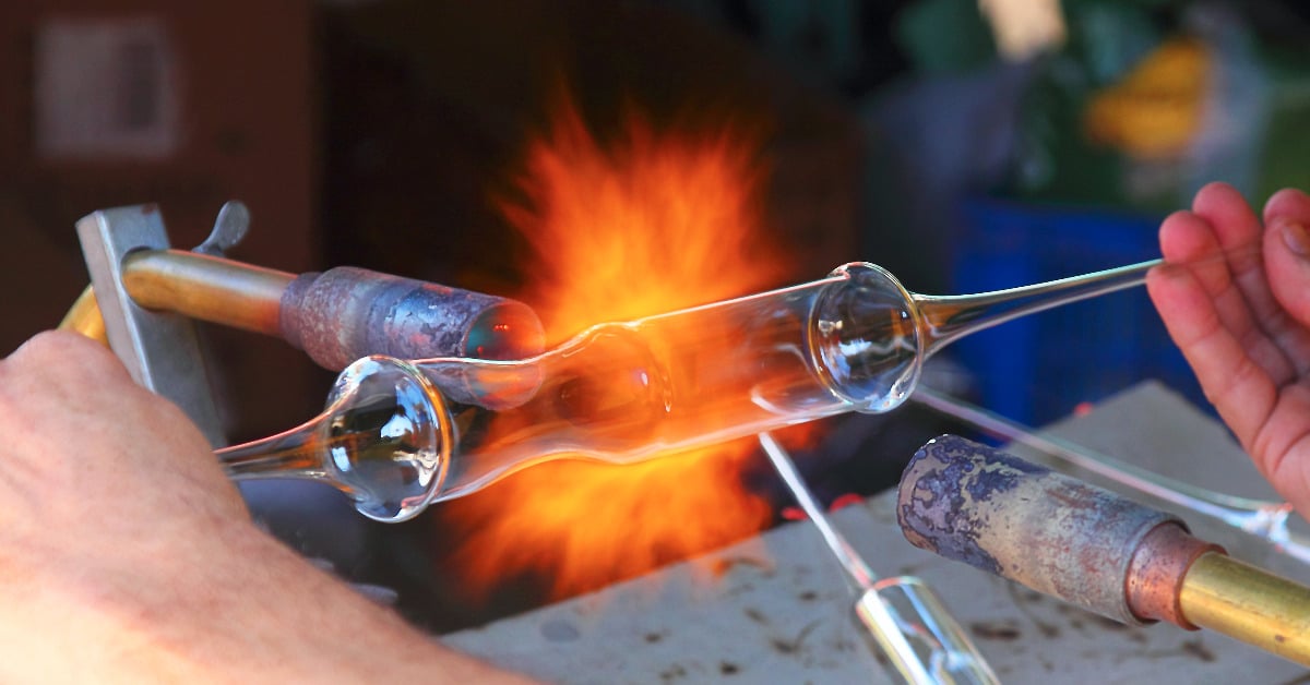 Artisan working with glass on a gas torch 