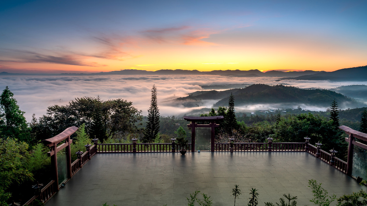 Gateway and Courtyard to a Hilltop Buddhist Temple Overlooking a Scenic Landscape